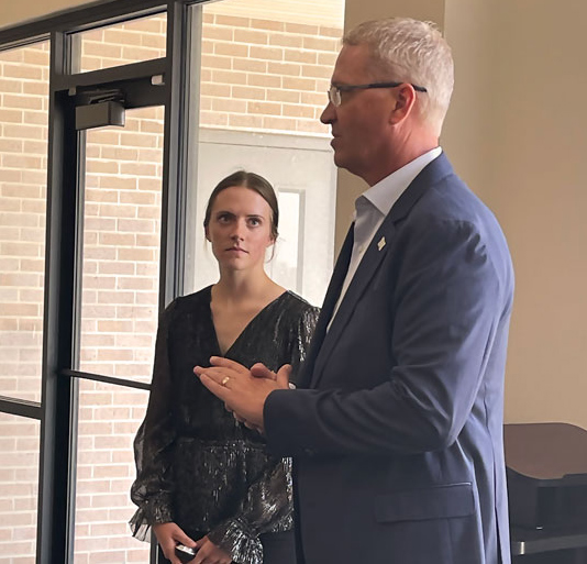2024 Summer Intern, Regan Ast, stands beside High Plains Farm Credit President and CEO, Kevin Swayne, during the presentation of her report to the board of directors.