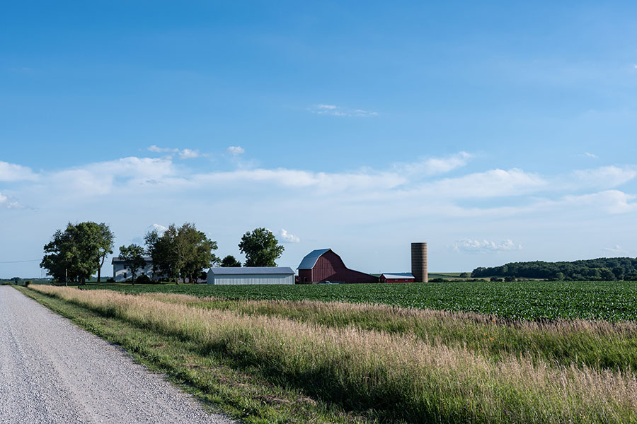 Scenic view of a rural home, barn, and farmland illustrating rural home loans for agricultural properties.