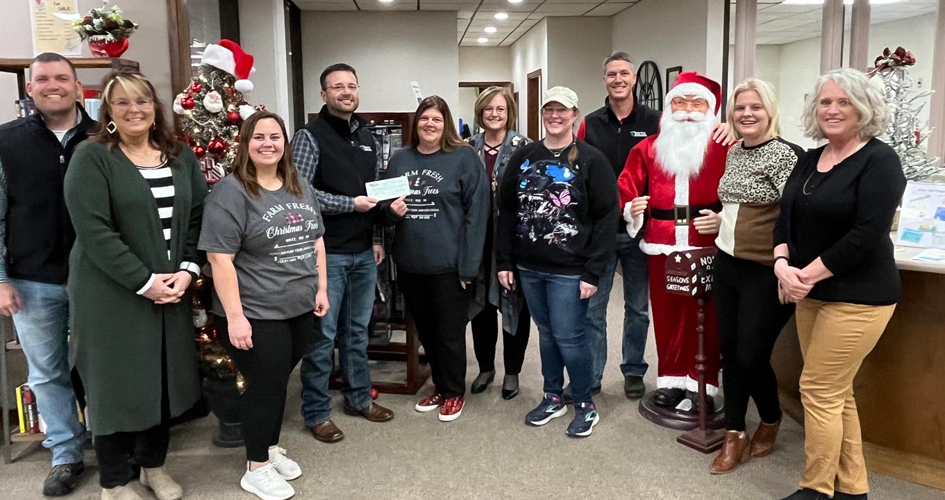 Larned staff present the Jordaan Library with a donation as part of 2023 December Giving.