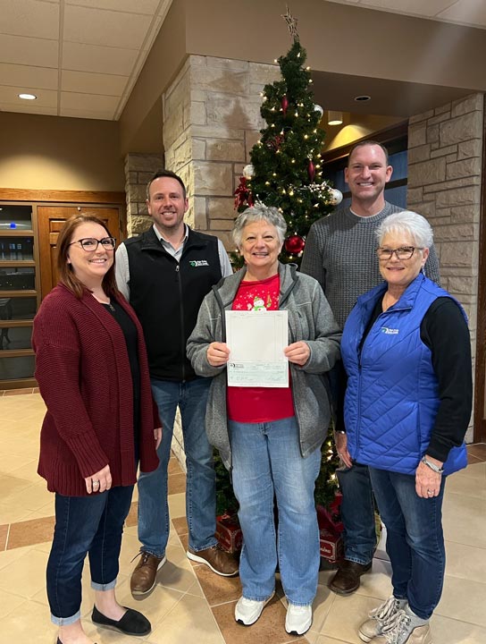 Ness City staff present a check to the Leisure Years Center as part of 2023 December Giving.