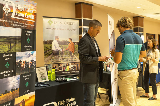 High Plains Farm Credit staff at a booth during the FHSU Career Fair, talking to students about employment opportunities.
