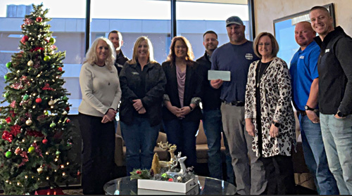 Larned staff present a check to the Burdett Volunteer Fire Department as part of 2024 December Giving.