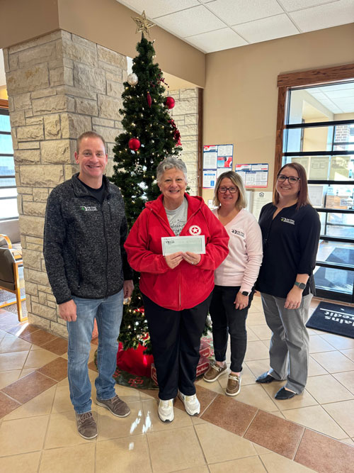 Ness City staff present a check to the Leisure Years Center as part of 2024 December Giving.