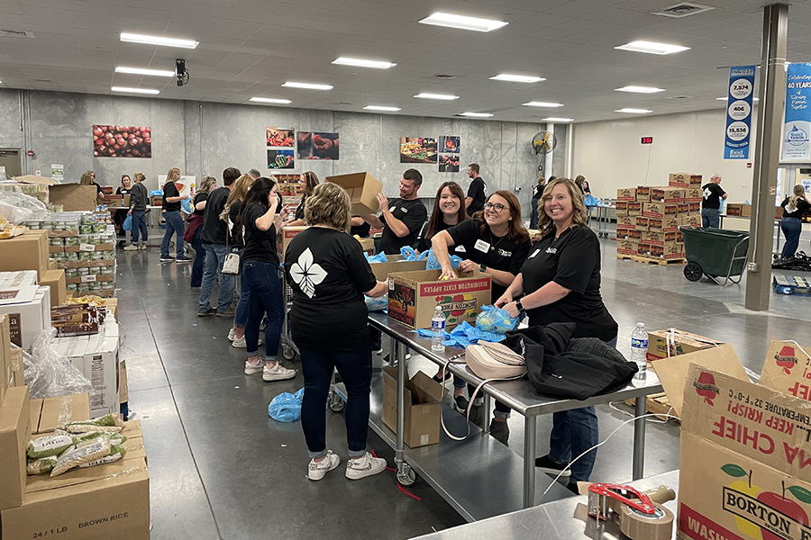 HPFC employees fill bags of apples to be delivered by the Kansas Food Bank to families in need.