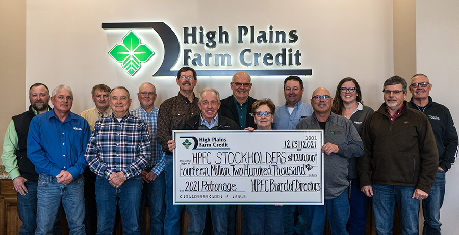 The High Plains Farm Credit Board of Directors poses with a large check, declaring record patronage of $14.2 million for the 2021 year.