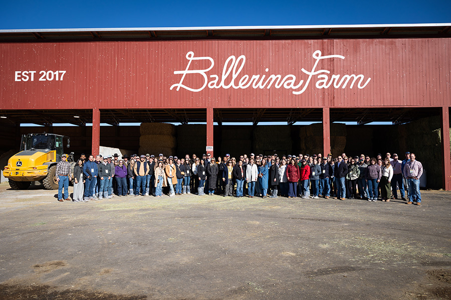 Young producers from around the country gather in front of the large, red barn that bears the text: "Ballerina Farm."