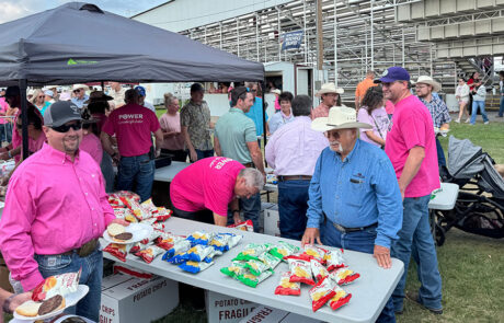 High Plains Farm Credit staff in Phillipsburg serve hamburgers to a hungry crowd before the first night of Kansas' Biggest Rodeo.