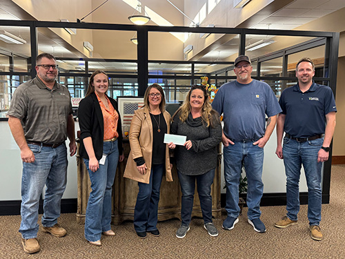 Ness City staff present a check to Kenzee Cares as part of 2025 December Giving.