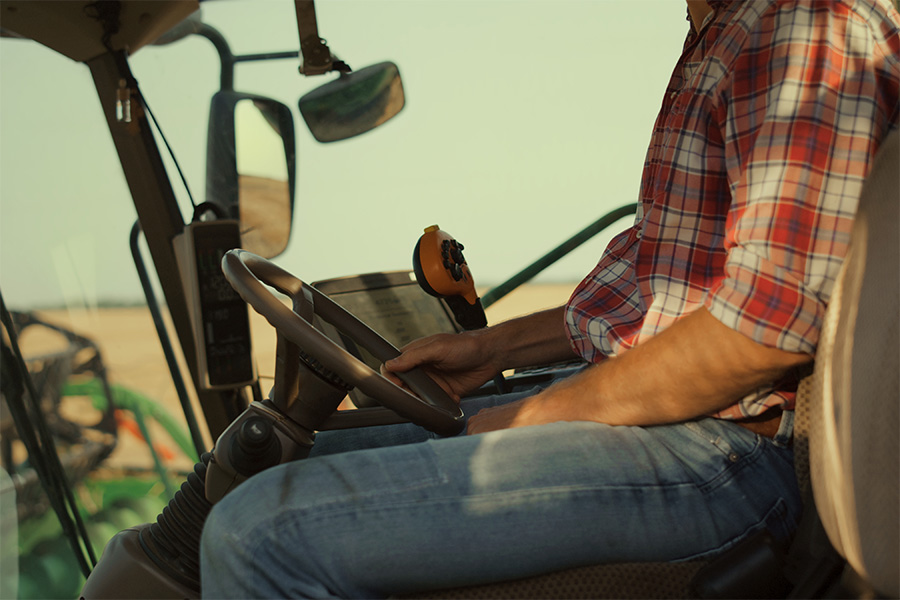 Farmer harvests wheat in a combine, a time that can often be stressful for those in the agriculture industry.