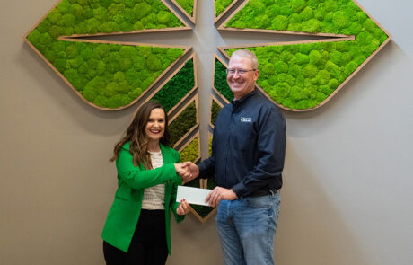 High Plains Farm Credit President and CEO, Kevin Swayne, shakes hands with a representative from the Kansas 4-H Foundation.