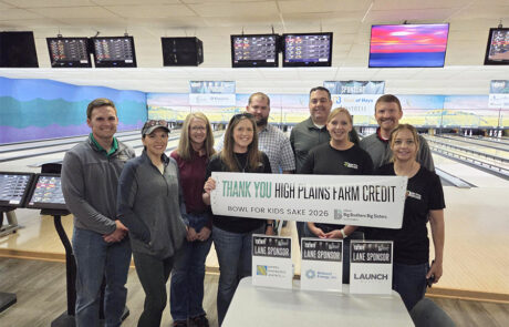 Members of the Hays team hold a sign thanking High Plains Farm Credit for its participation in the 2026 Bowl for Kids' Sake event.